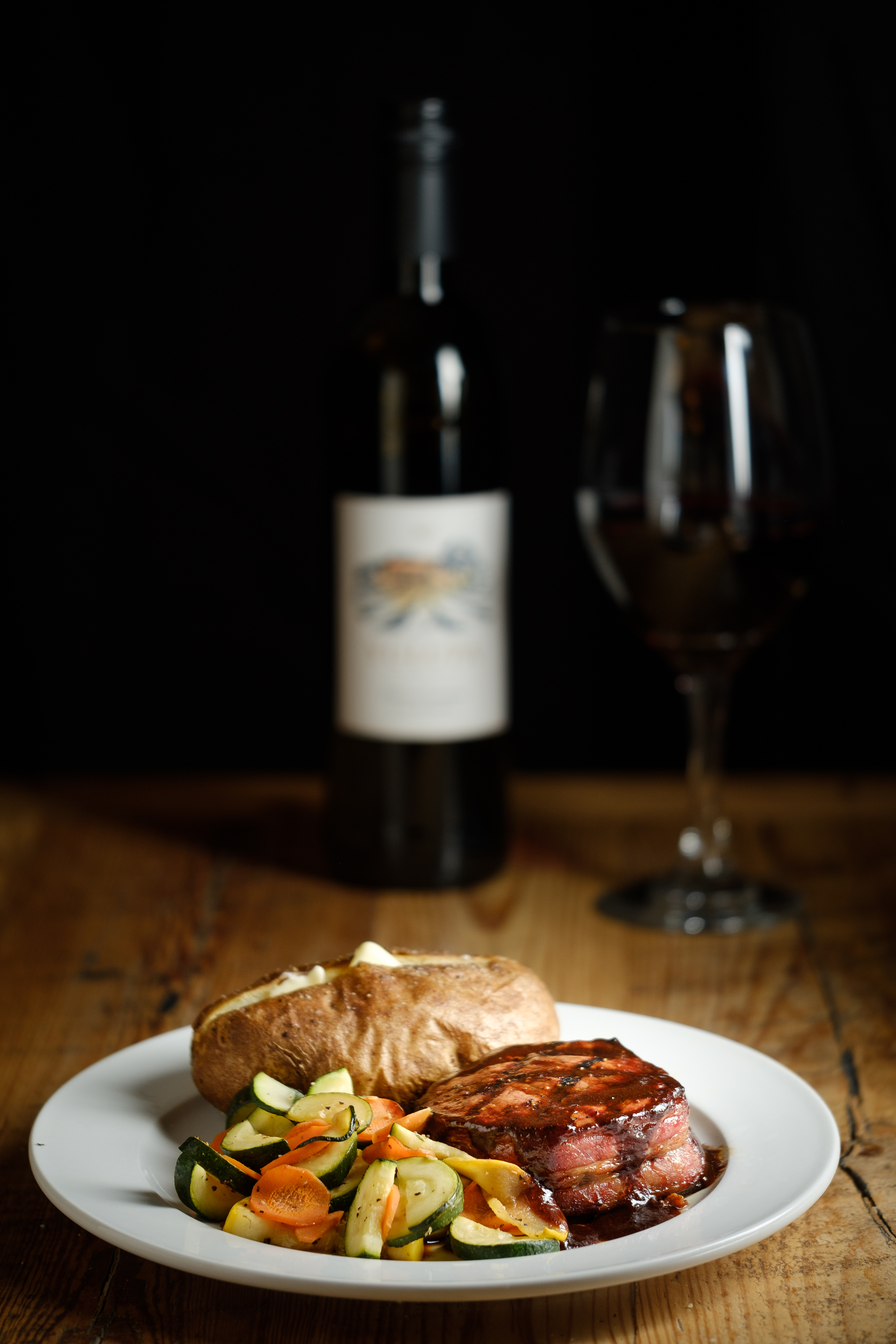 dinner plate with bottle of wine