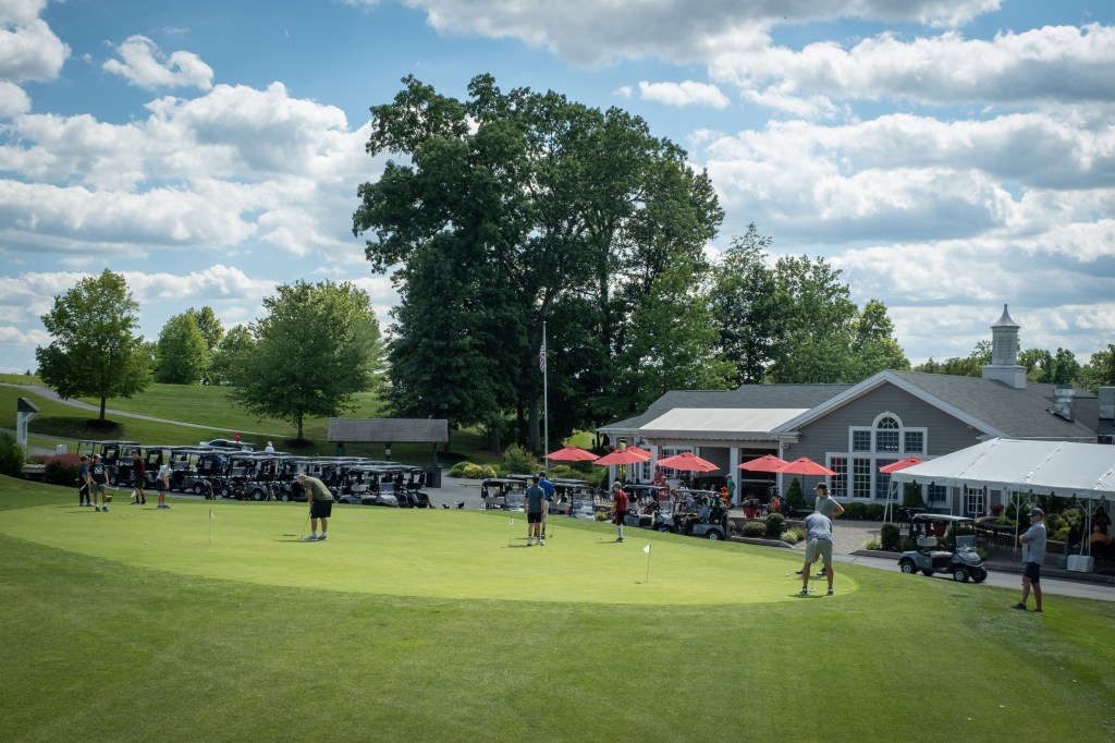 golfers at the putting area